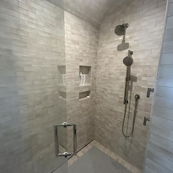 Walk-in tile shower with glass door installed by KW Plumbing